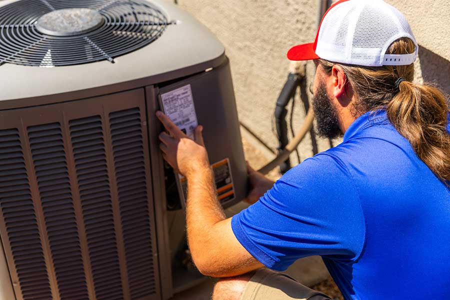 Technician performing AC maintenance